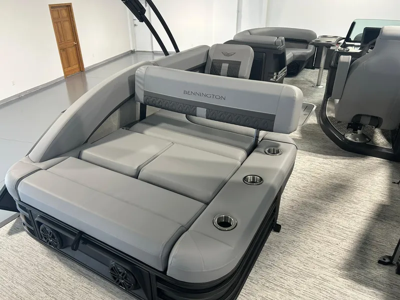 Slide: The Image of 2025 Bennington 22 MSB boat interior with gray seating and cup holders. - 16