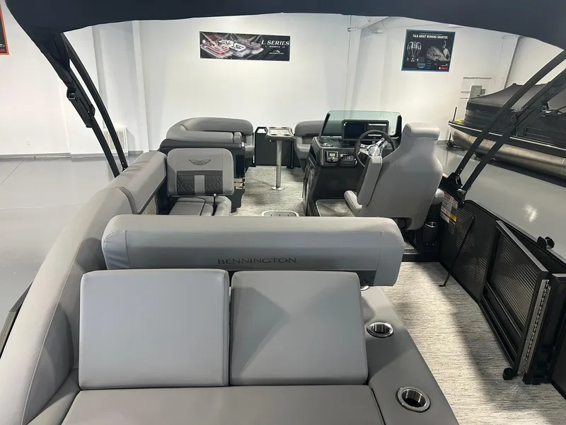 Slide: The Image of 2025 Bennington 22 MSB pontoon boat interior with luxurious seating and modern dashboard. - 18