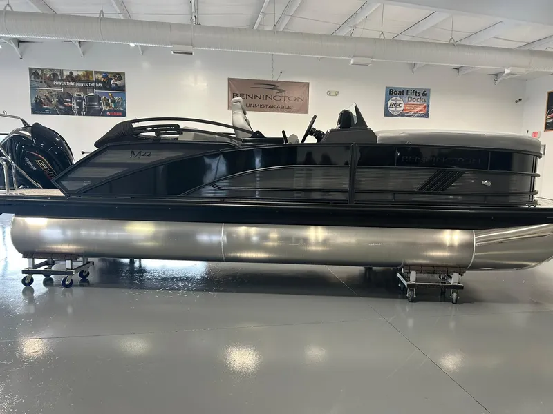 Slide: The Image of 2025 Bennington 22 MSB pontoon boat in showroom, sleek black design. - 3