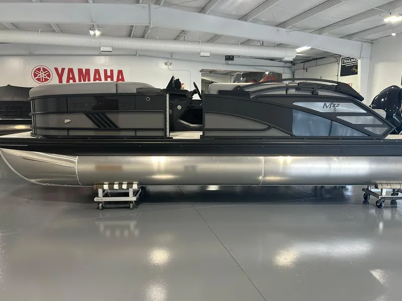 Slide: The Image of 2025 Bennington 22 MSB pontoon boat displayed in a showroom with Yamaha branding. - 6
