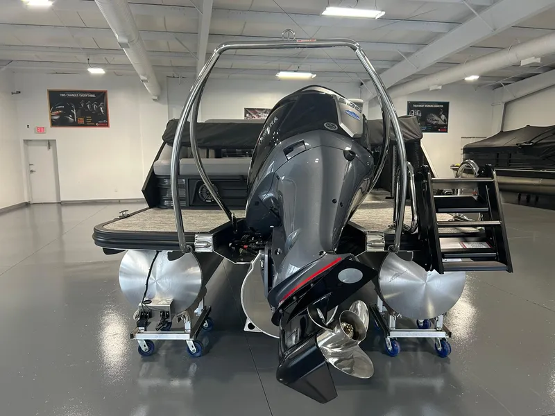 Slide: The Image of 2025 Bennington 22 MSB pontoon boat with powerful outboard motor in showroom. - 7