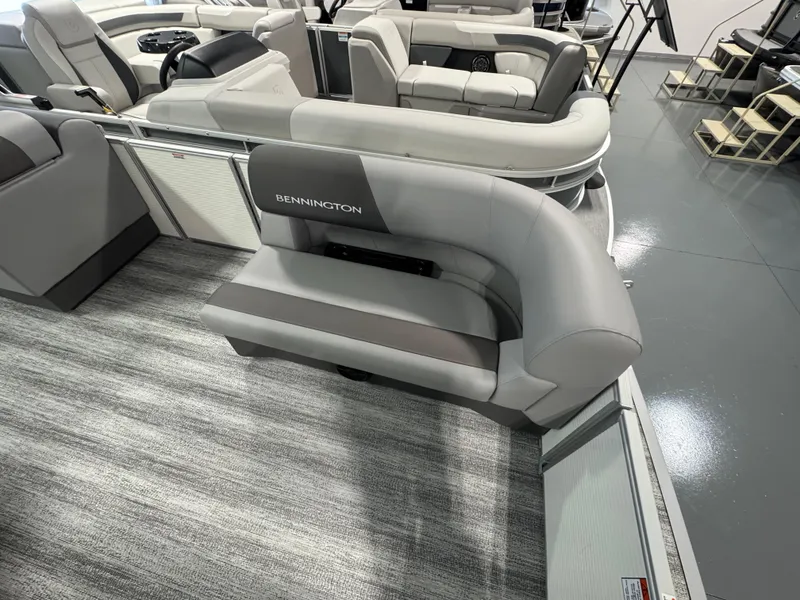 Slide: The Image of 2025 Bennington 20 SL pontoon boat interior with gray seating and modern design. - 4