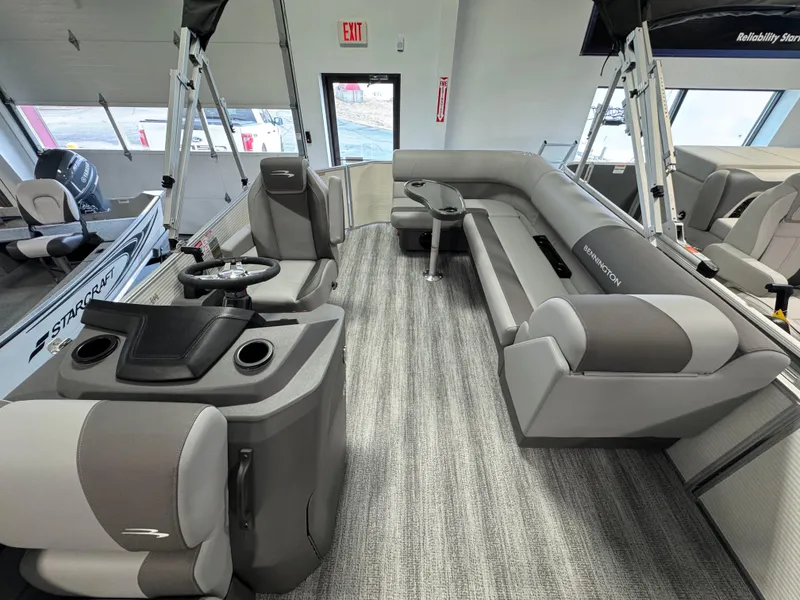Slide: The Image of 2025 Bennington 20 SL pontoon boat interior with modern seating and steering console. - 5