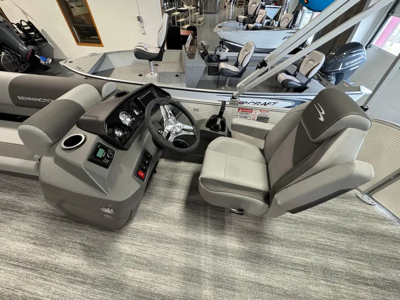 Slide: The Image of 2025 Bennington 20 SL boat interior with steering console and seating. - 6