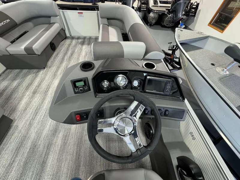 Slide: The Image of Interior view of 2025 Bennington 20 SL boat, featuring steering wheel and dashboard controls. - 7