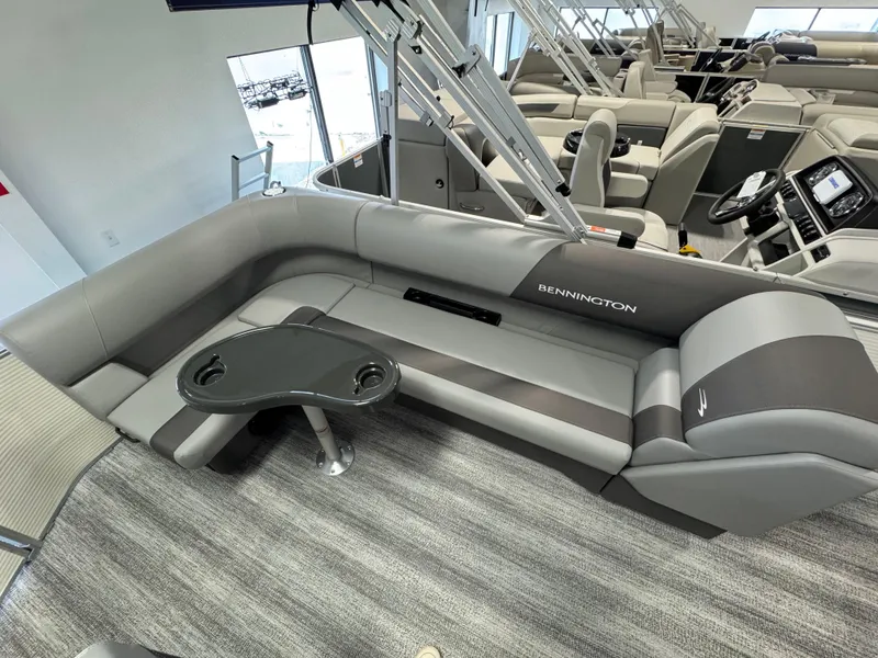Slide: The Image of 2025 Bennington 20 SL pontoon boat interior with gray seating and table. - 8