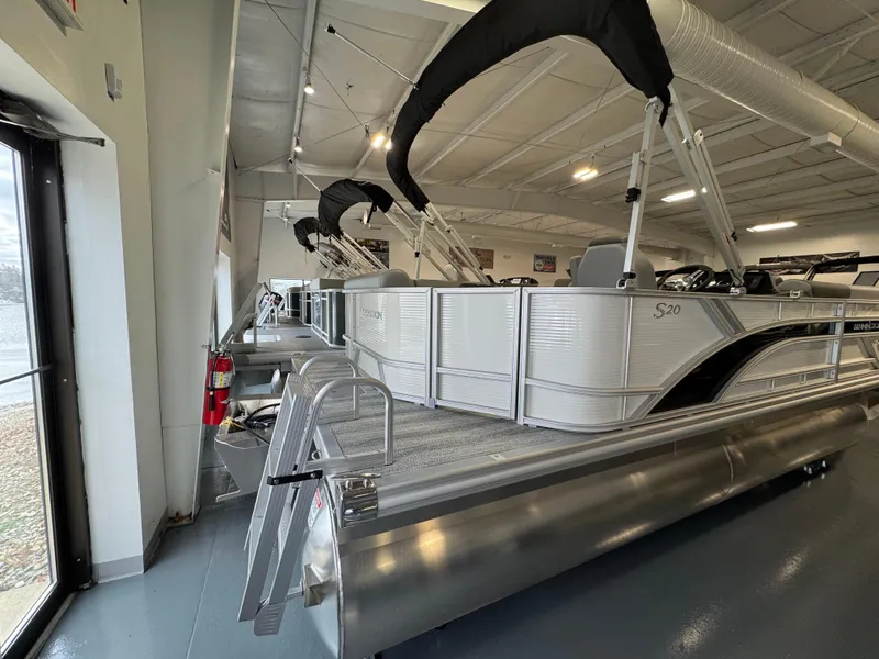 Slide: The Image of 2025 Bennington 20 SL pontoon boat displayed in a showroom. - 9