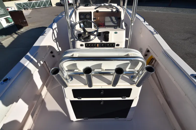 Slide: The Image of 2005 Grady-White Escape 209 boat interior with steering wheel and rod holders. - 21