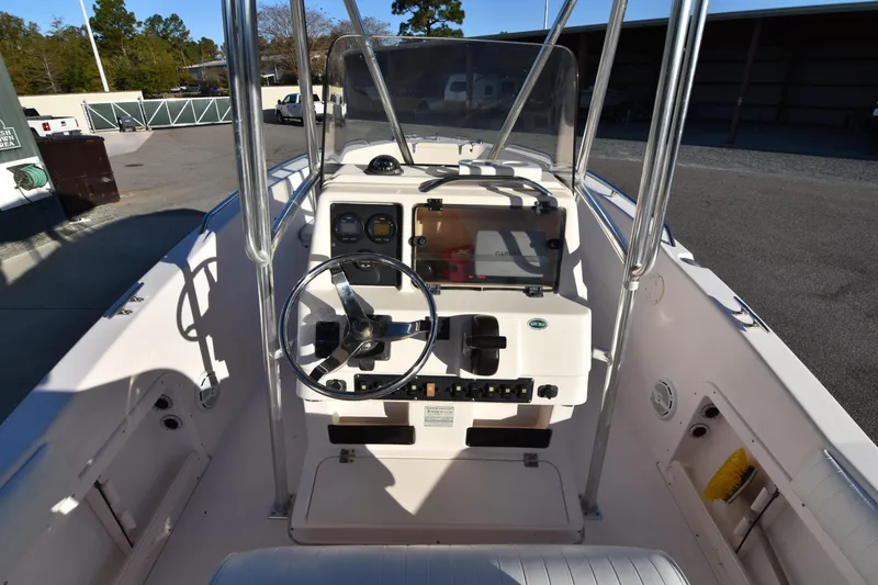 Slide: The Image of 2005 Grady-White Escape 209 boat console with steering wheel and controls. - 22