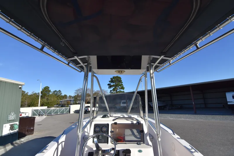 Slide: The Image of 2005 Grady-White Escape 209 boat interior with steering console and canopy. - 23