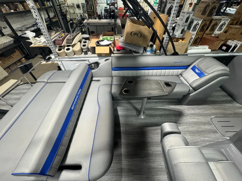 Slide: The Image of Interior of 2025 Bennington 24 LXSSB boat with gray seating and table. - 10