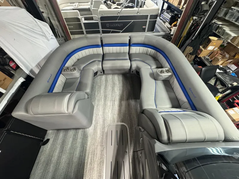 Slide: The Image of 2025 Bennington 24 LXSSB pontoon boat interior with luxurious gray seating and blue accents. - 5