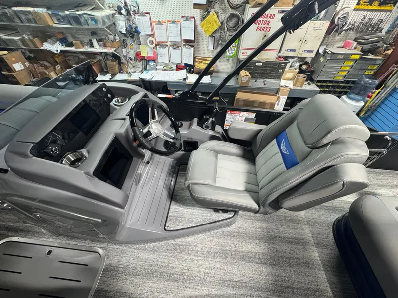 Slide: The Image of Interior of 2025 Bennington 24 LXSSB boat with steering wheel and captain's chair. - 7