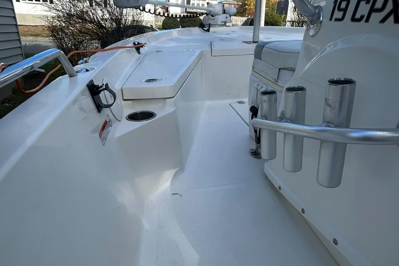 Slide: The Image of 2018 Mako 19 CPX boat interior with rod holders and seating. - 10