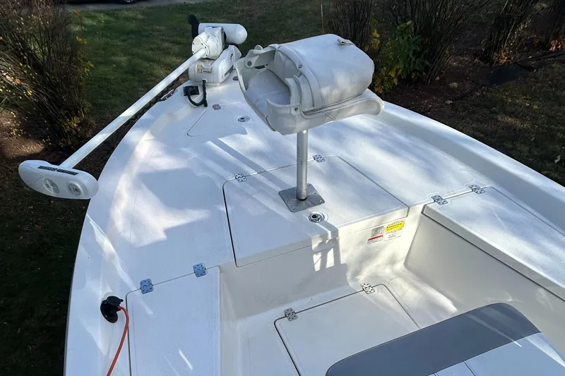 Slide: The Image of 2018 Mako 19 CPX boat deck with trolling motor and storage compartments. - 11