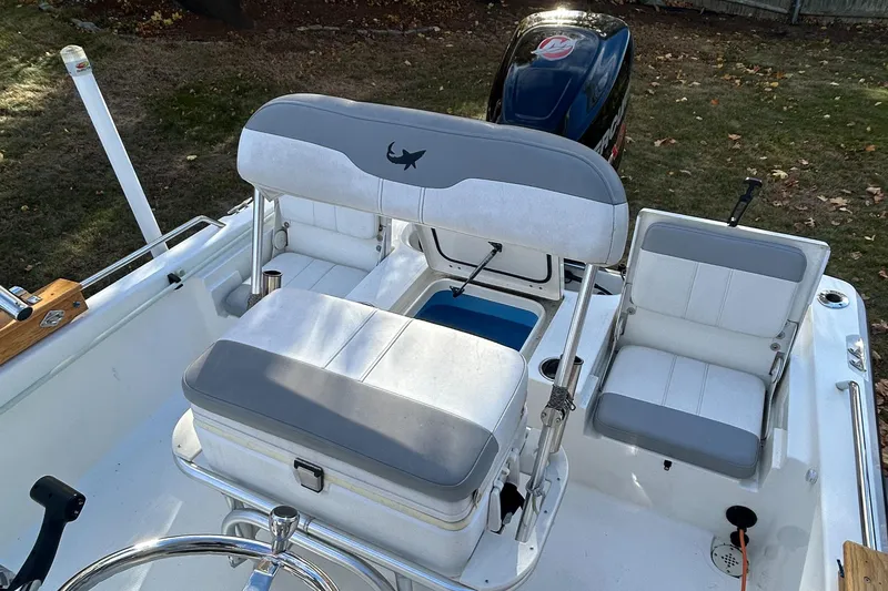 Slide: The Image of 2018 Mako 19 CPX boat interior with seating and steering wheel. - 15