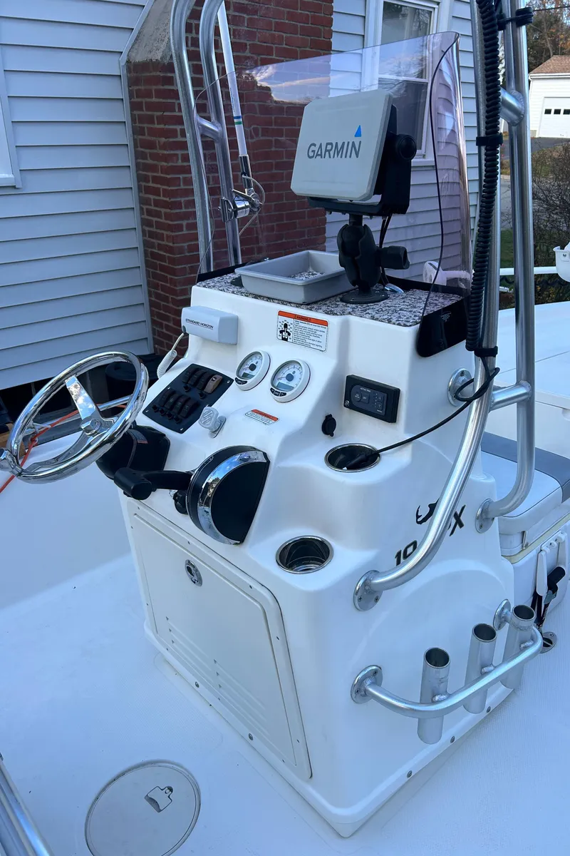 Slide: The Image of 2018 Mako 19 CPX boat console with Garmin navigation system. - 17