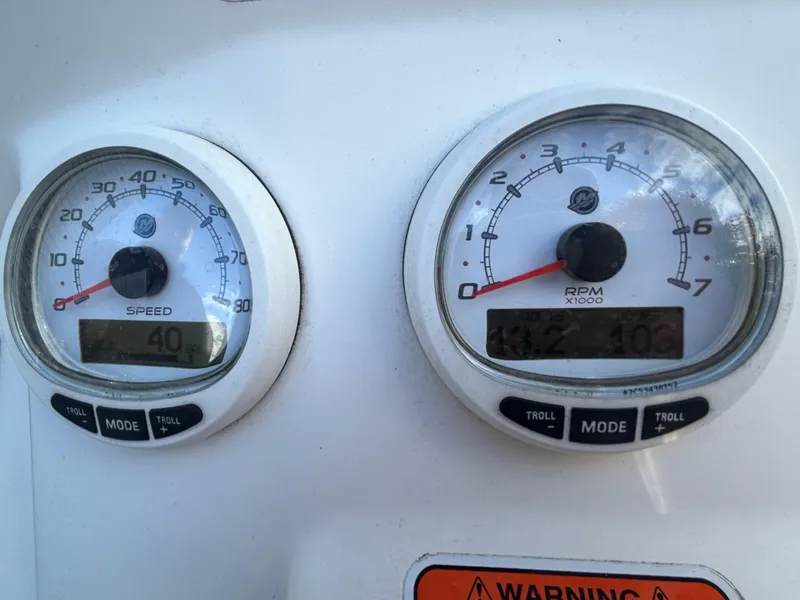 Slide: The Image of Close-up of 2018 Mako 19 CPX boat speedometer and tachometer gauges. - 21