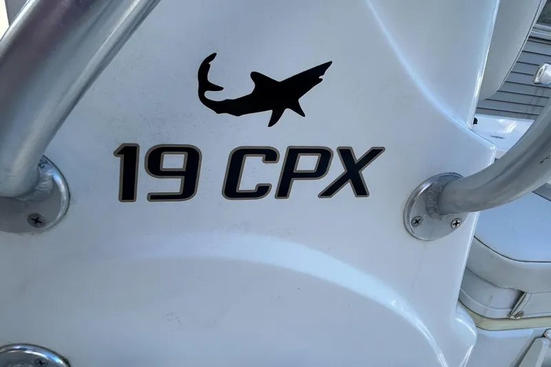 Slide: The Image of Close-up of 2018 Mako 19 CPX boat logo with shark silhouette. - 27