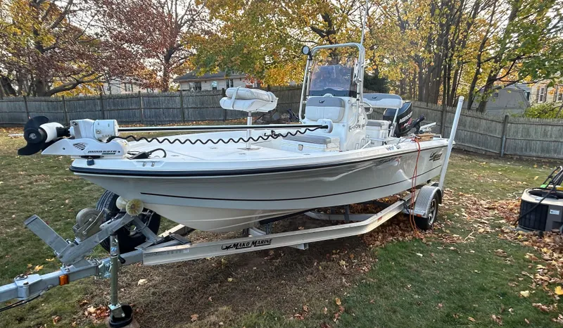 Slide: The Image of 2018 Mako 19 CPX boat on trailer in a grassy yard. - 3