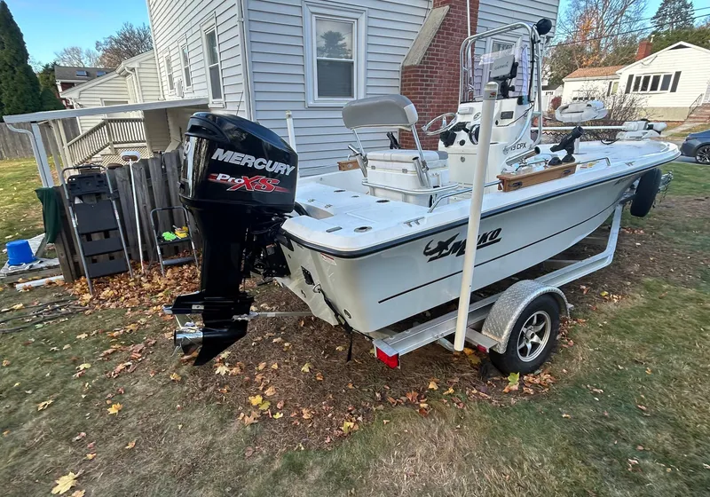Slide: The Image of 2018 Mako 19 CPX boat with Mercury engine on trailer in residential yard. - 5