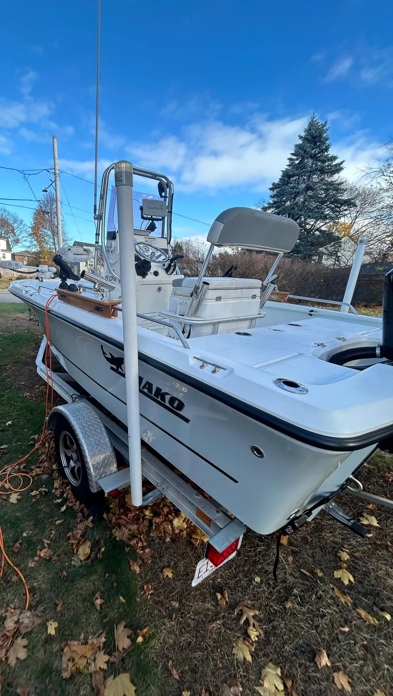 Slide: The Image of 2018 Mako 19 CPX boat on trailer, parked outdoors on grass. - 6