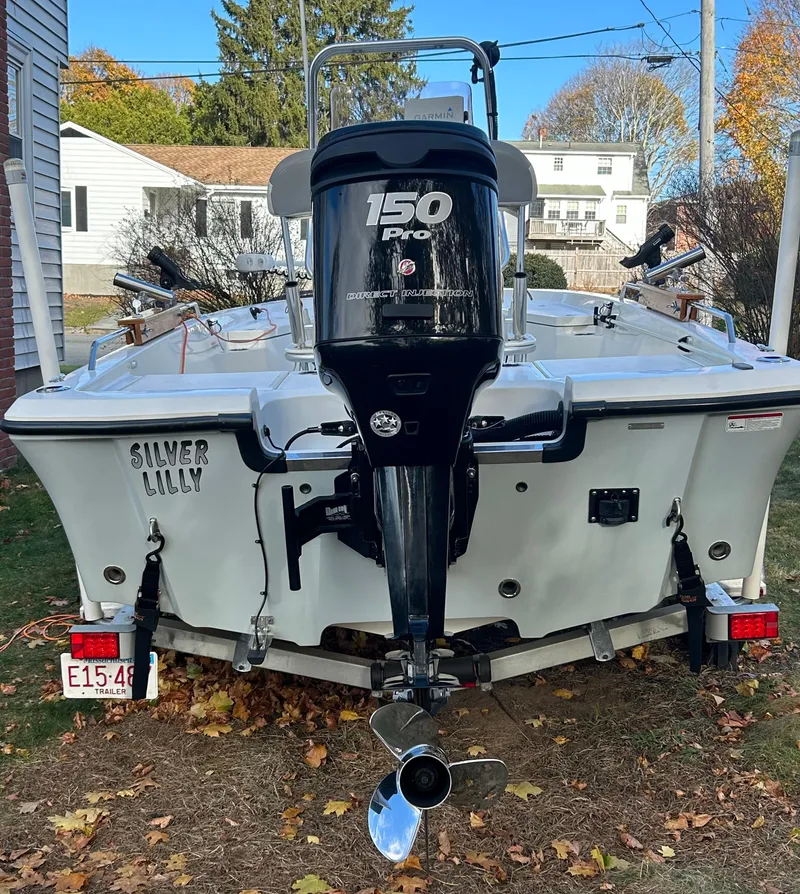 Slide: The Image of 2018 Mako 19 CPX boat with 150 Pro motor, parked outdoors. - 7