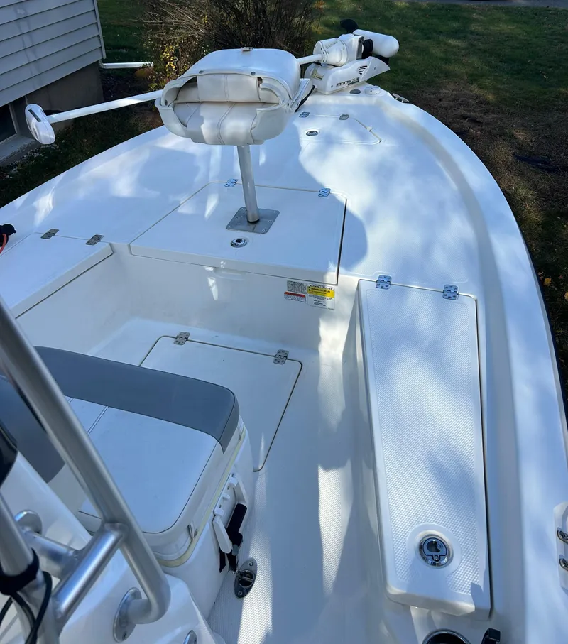 Slide: The Image of 2018 Mako 19 CPX boat interior with seating and storage compartments. - 8