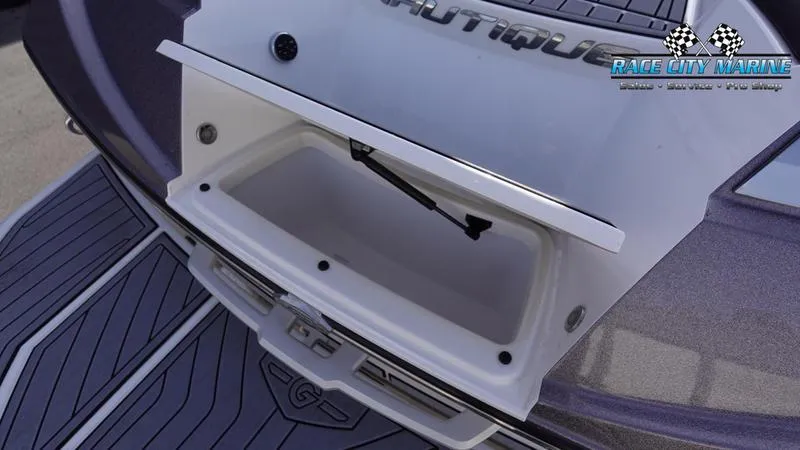Slide: The Image of 2017 Nautique Super Air Nautique G23 storage compartment, Race City Marine branding. - 12