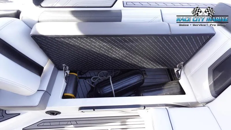 Slide: The Image of 2017 Nautique Super Air Nautique G23 storage compartment with marine accessories. - 26