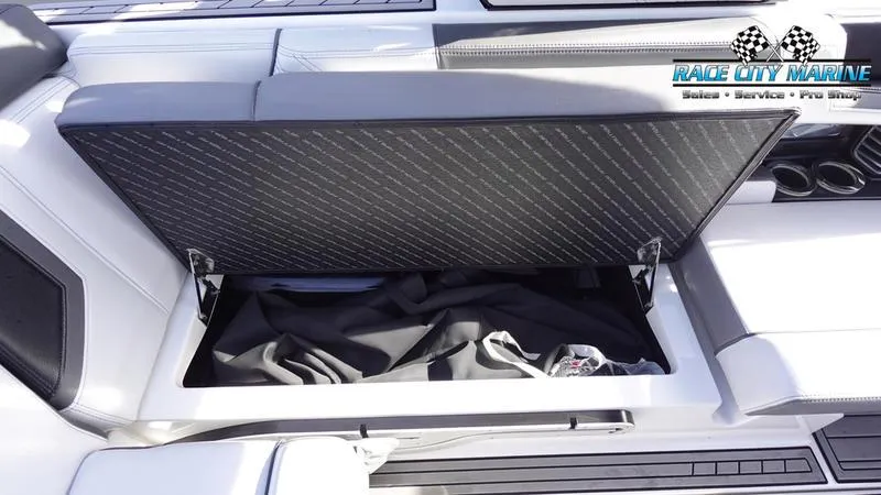 Slide: The Image of 2017 Nautique Super Air Nautique G23 boat storage compartment open, showing interior space. - 27