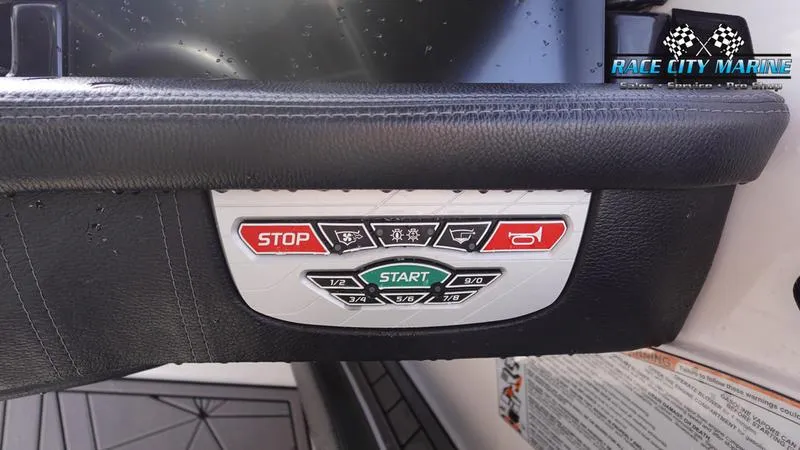 Slide: The Image of Control panel of 2017 Nautique Super Air Nautique G23 boat with start and stop buttons. - 37