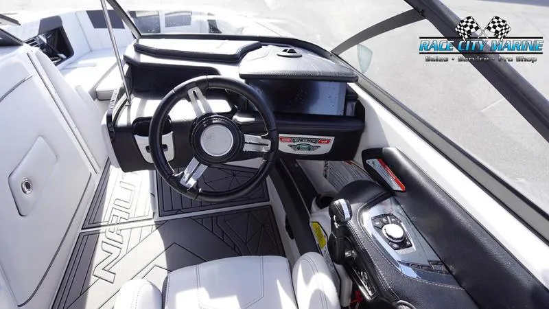 Slide: The Image of 2017 Nautique Super Air Nautique G23 boat interior with steering wheel and dashboard. - 48
