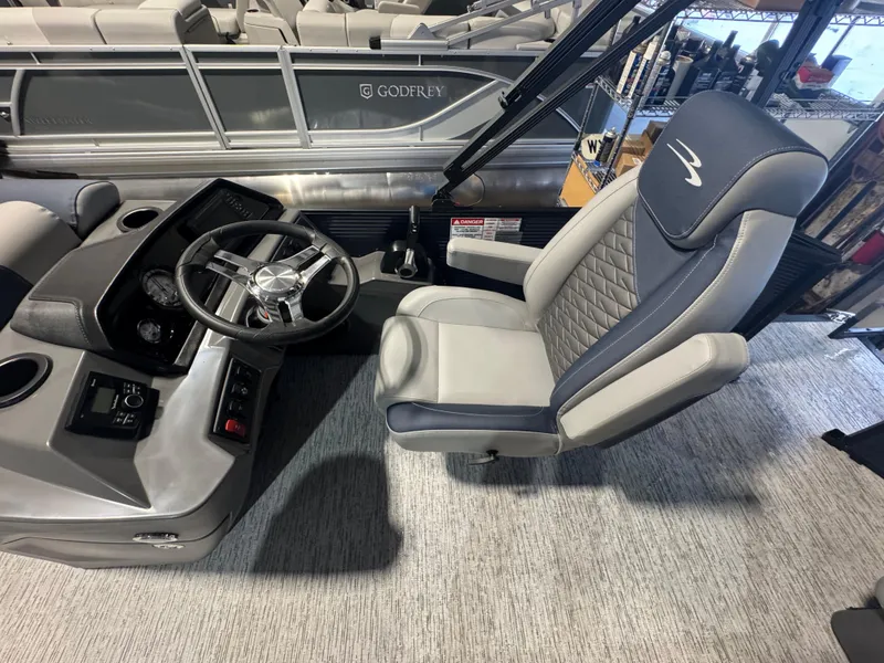 Slide: The Image of Captain's seat and helm of 2025 Bennington 20 SL pontoon boat, featuring modern design. - 4