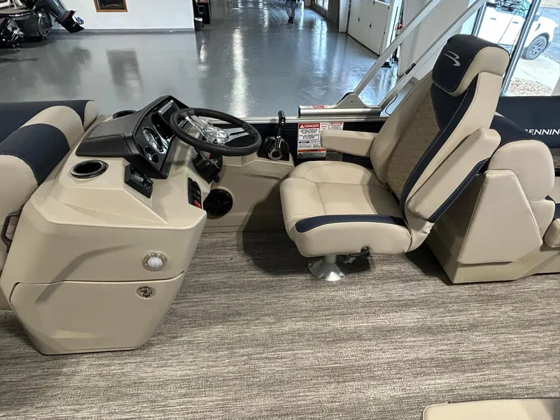 Slide: The Image of 2025 Bennington 22 SSR boat interior with captain's chair and steering console. - 10