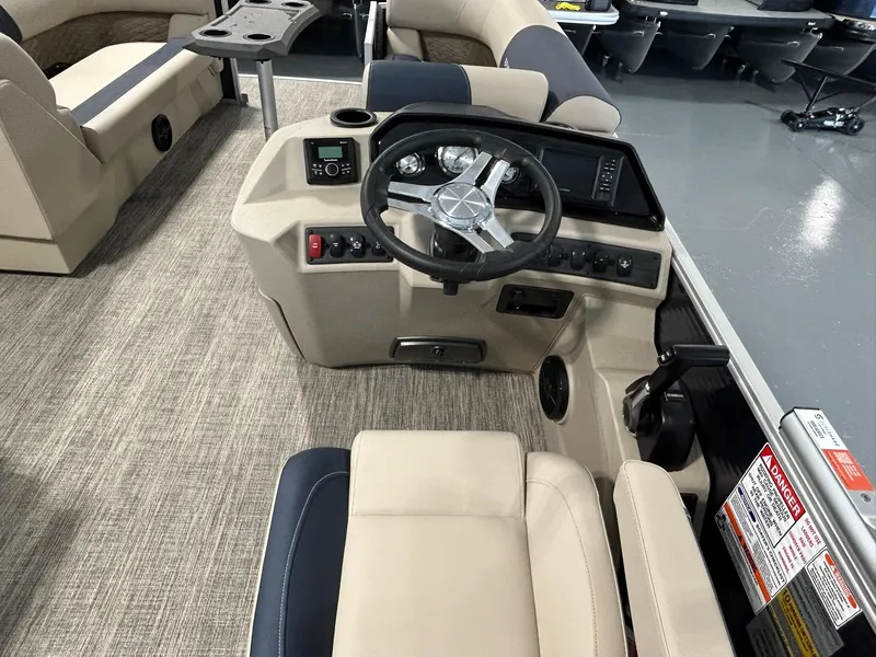 Slide: The Image of 2025 Bennington 22 SSR boat interior with steering console and seating. - 11