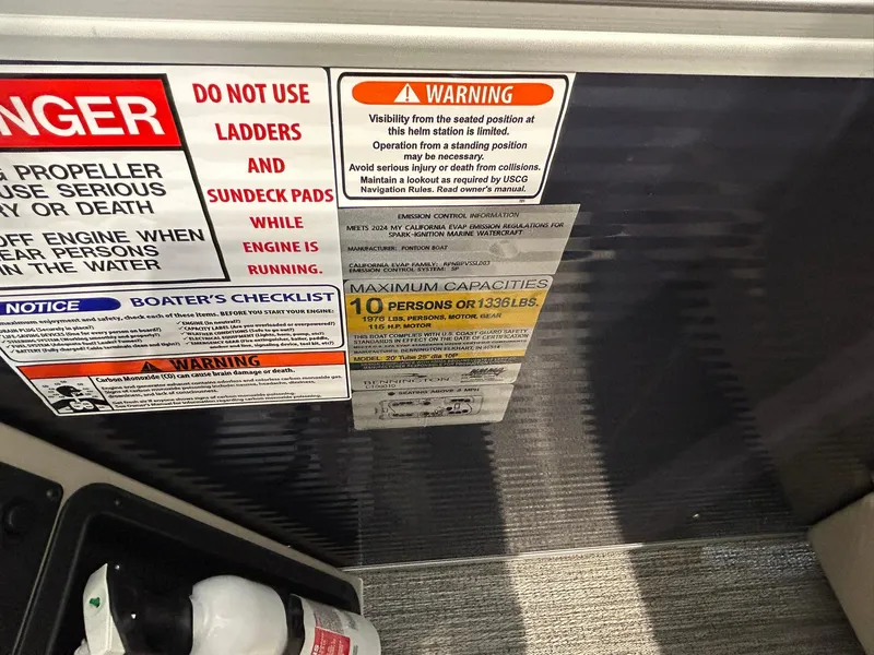 Slide: The Image of Warning and capacity labels on a 2025 Bennington 22 SSR boat, highlighting safety instructions. - 13