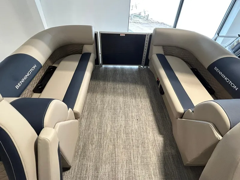 Slide: The Image of 2025 Bennington 22 SSR pontoon boat interior with beige and navy seating. - 14