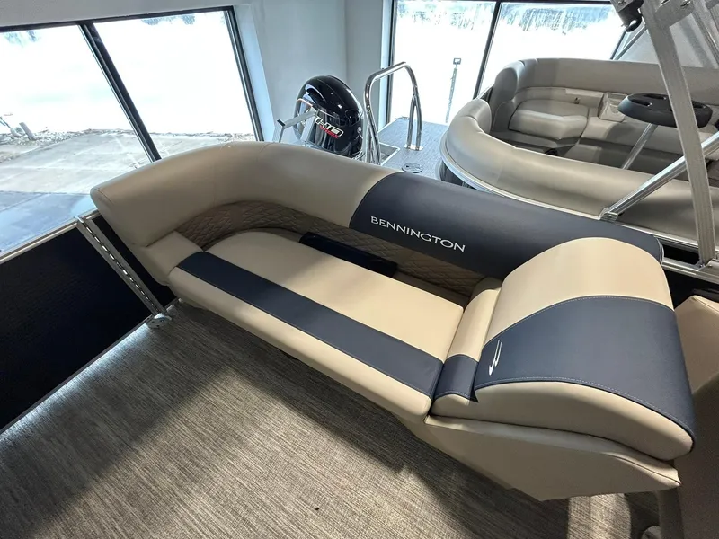Slide: The Image of 2025 Bennington 22 SSR boat interior with beige and navy seating. - 16