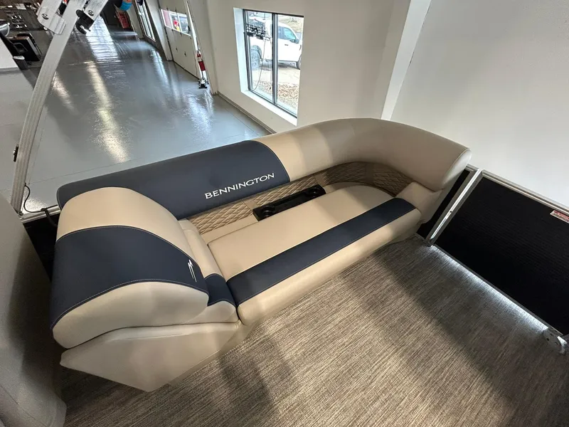 Slide: The Image of 2025 Bennington 22 SSR boat interior with beige and navy seating. - 17