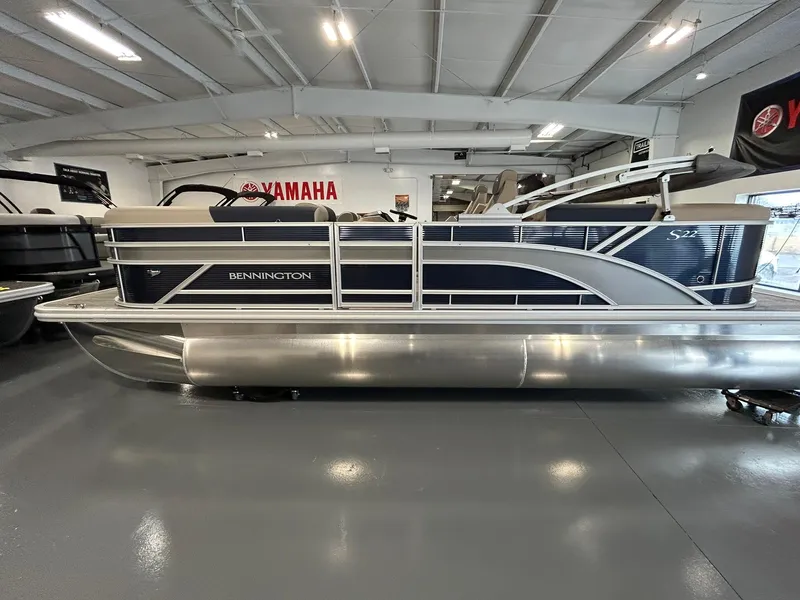 Slide: The Image of 2025 Bennington 22 SSR pontoon boat in showroom, side view. - 2