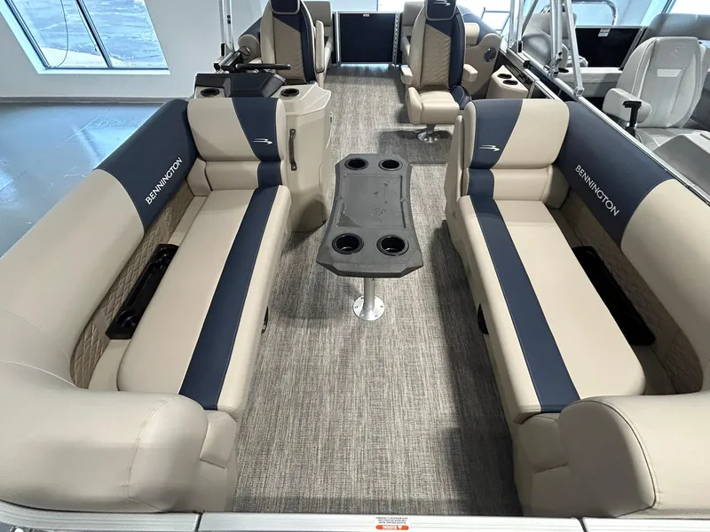 Slide: The Image of 2025 Bennington 22 SSR pontoon boat interior with beige and navy seating. - 6