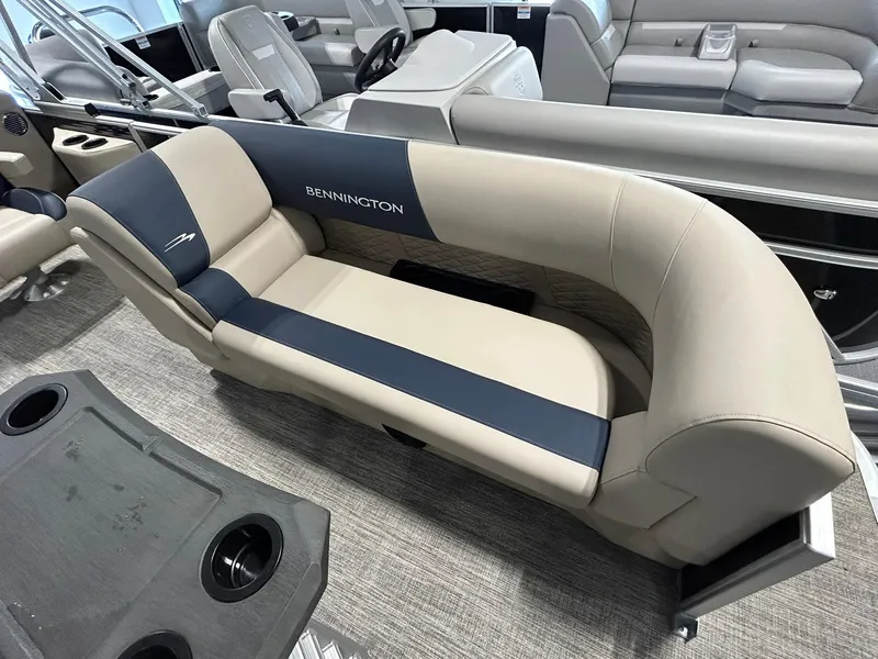 Slide: The Image of 2025 Bennington 22 SSR boat interior with beige and navy seating. - 7