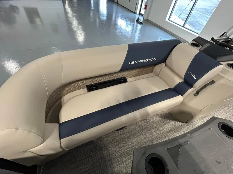 Slide: The Image of 2025 Bennington 22 SSR boat interior with beige and navy seating. - 8