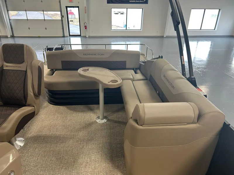 Slide: The Image of 2025 Bennington 22 SXSB boat interior with beige seating and table. - 11