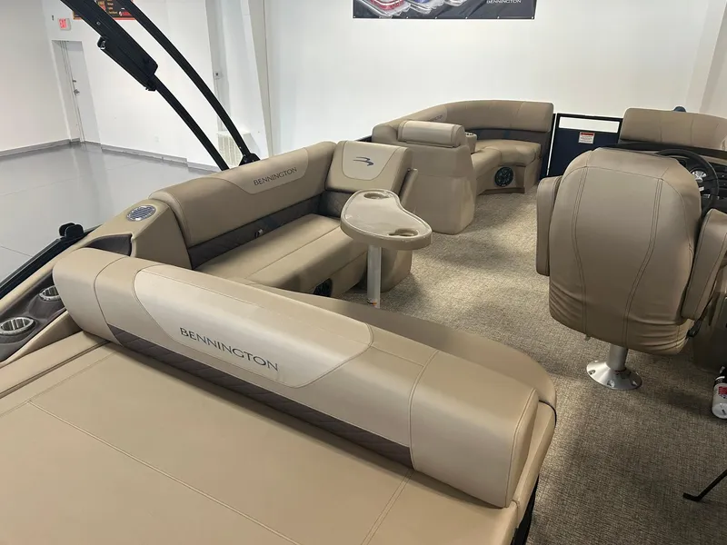 Slide: The Image of 2025 Bennington 22 SXSB boat interior with beige seating and modern design. - 12