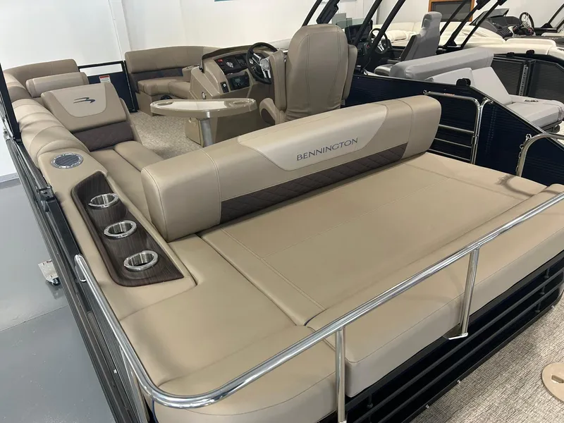 Slide: The Image of 2025 Bennington 22 SXSB pontoon boat with luxurious beige seating and cup holders. - 13