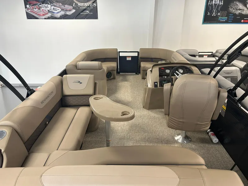 Slide: The Image of 2025 Bennington 22 SXSB pontoon boat interior with beige seating and helm. - 15