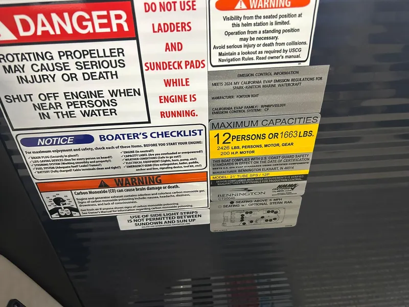 Slide: The Image of Warning and capacity labels on a 2025 Bennington 22 SXSB boat. - 16