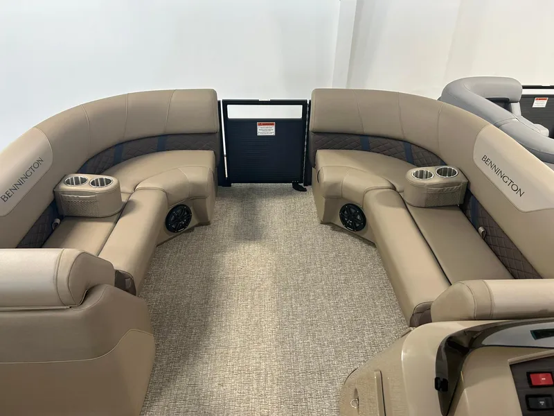 Slide: The Image of 2025 Bennington 22 SXSB boat interior with beige seating and cup holders. - 5